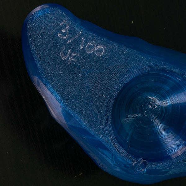 Close up of the signature on a blue croissant lamp