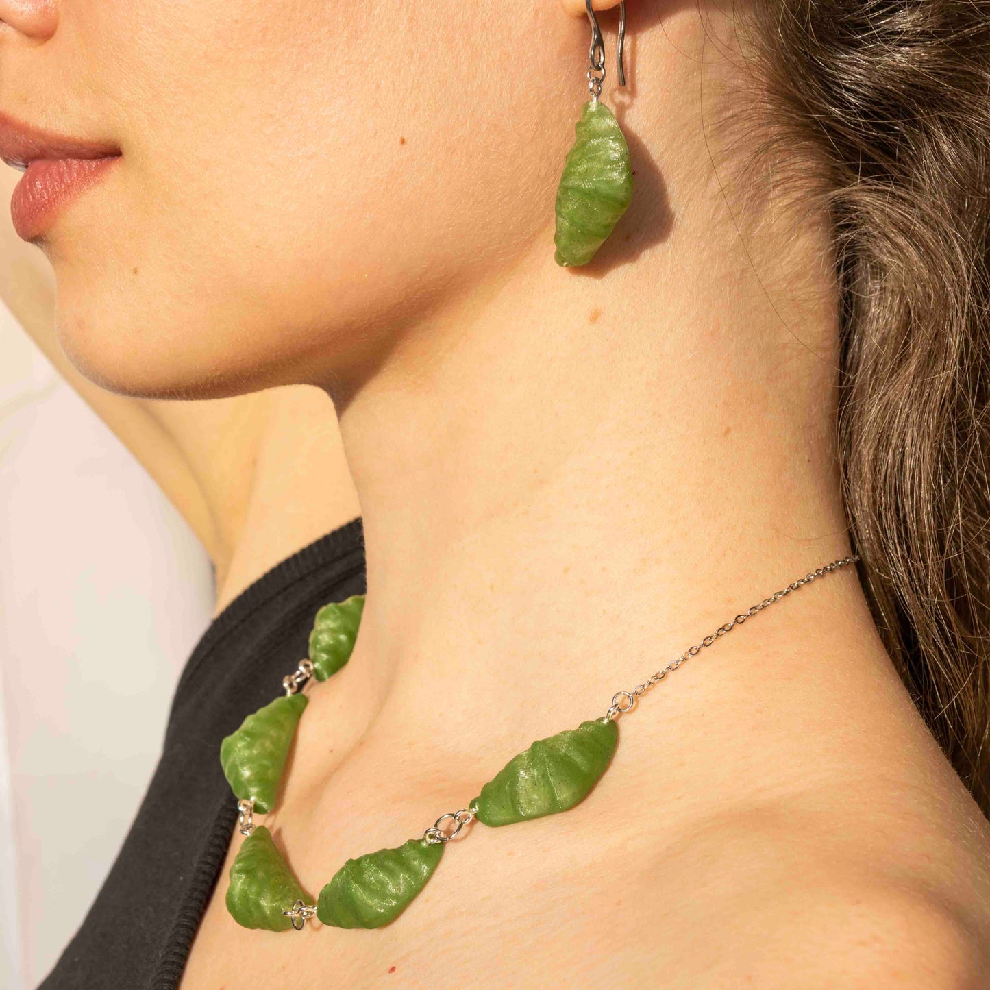 cute, statement collar necklace. silver stainless steal. hemp green color. croissant shaped. sustainable locally made nacklace