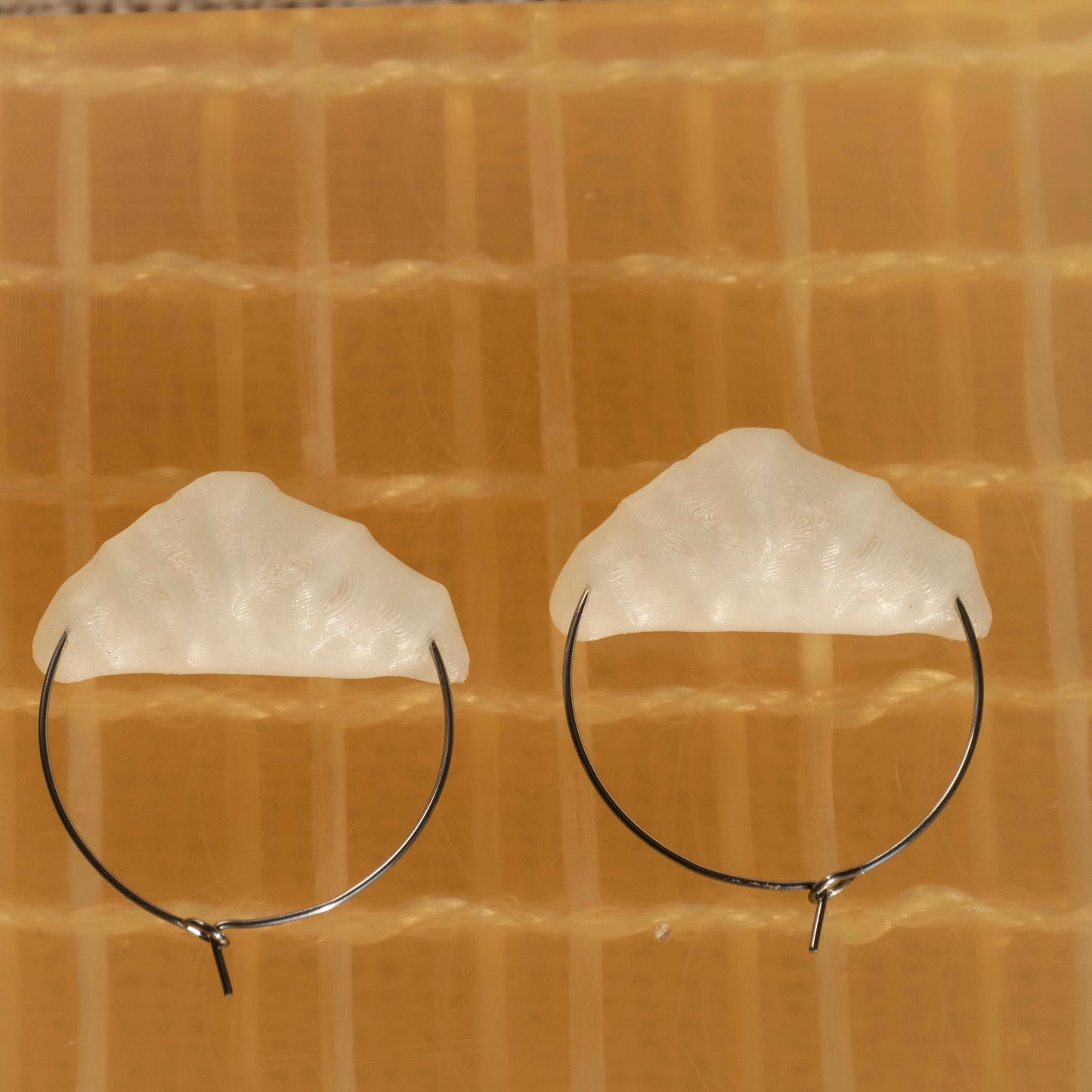 cute, statement hoop earrings. silver stainless steal. seashell white color. croissant shaped. sustainable locally made earrings